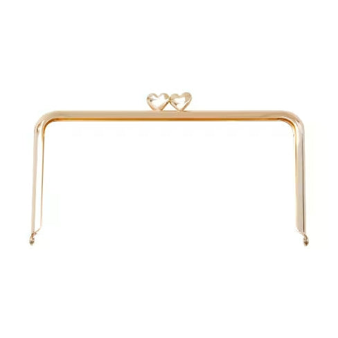Gold frame clutch with heart design on a white background