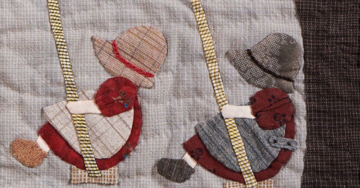 A quilted appliqué design shows two children swinging under a tree. They wear sun hats, dresses, and aprons.